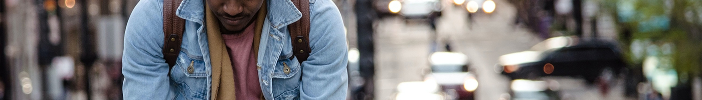 Man leaning over with city streets in the background