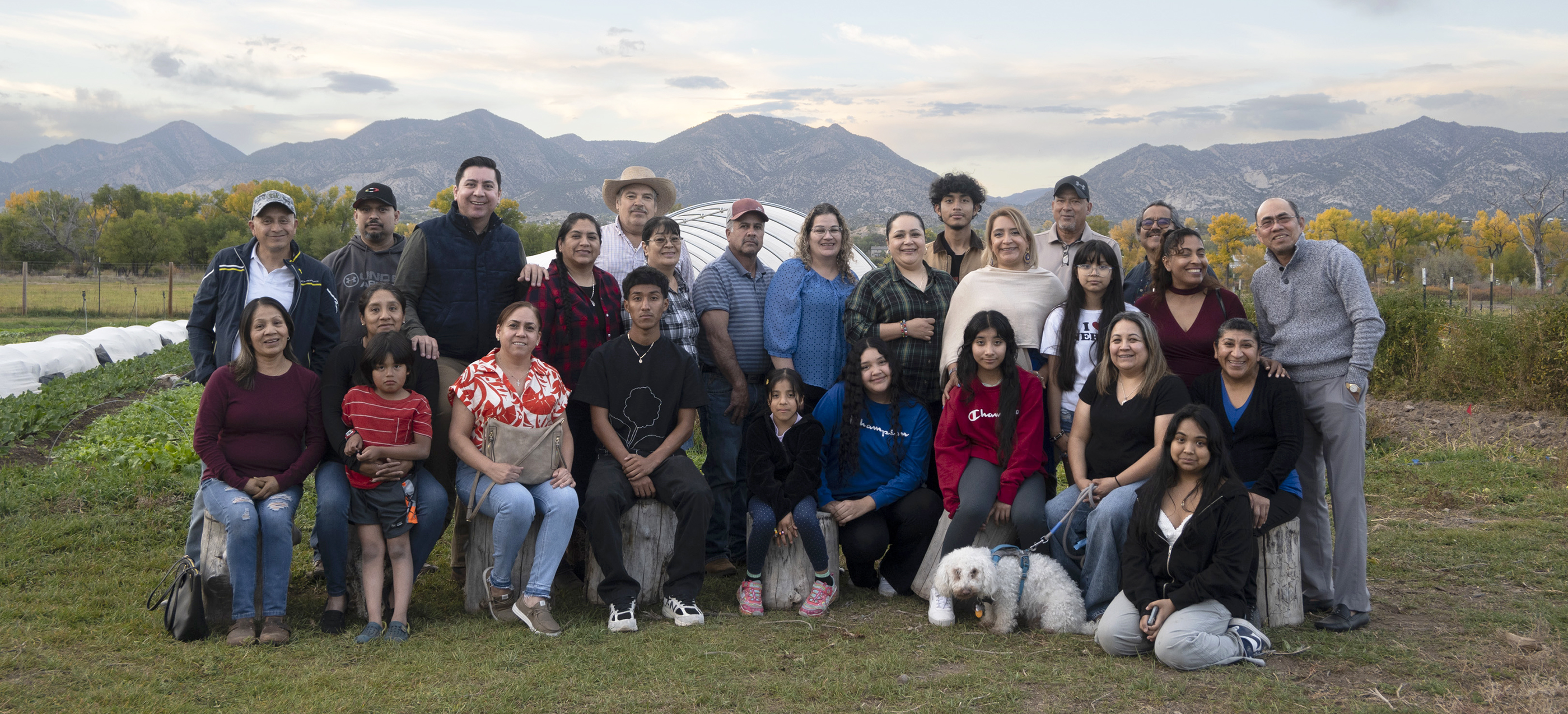 About two dozen members of the Safe and Abundant Nutrition Alliance (SANA) pose for a photo with mountains in the background. The group serves Eagle, Pitkin, and Garfield counties, known locally as the Valley.