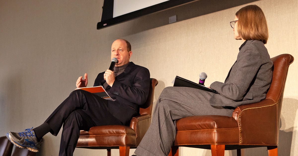 Sara Schmitt interviews Gov. Jared Polis on stage at the Hot Issues in Health conference.