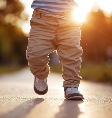 Toddler walking down a path at dusk