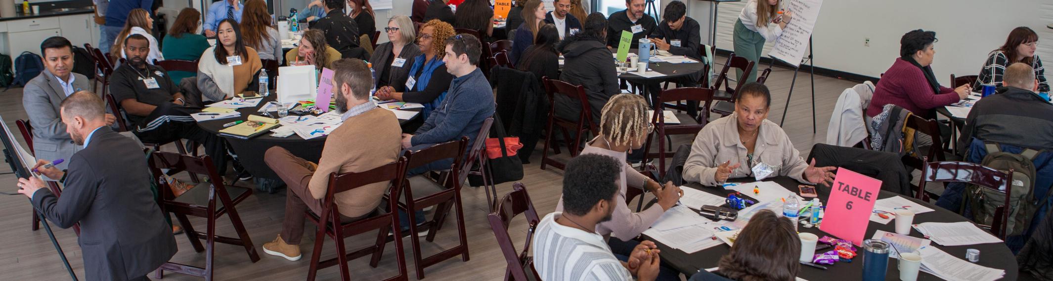 A diverse group of people discuss behavioral health workforce pathways