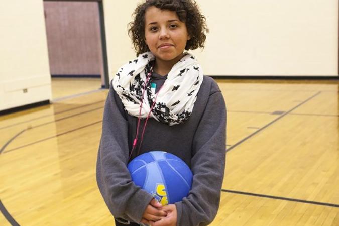 A girl holding a basketball