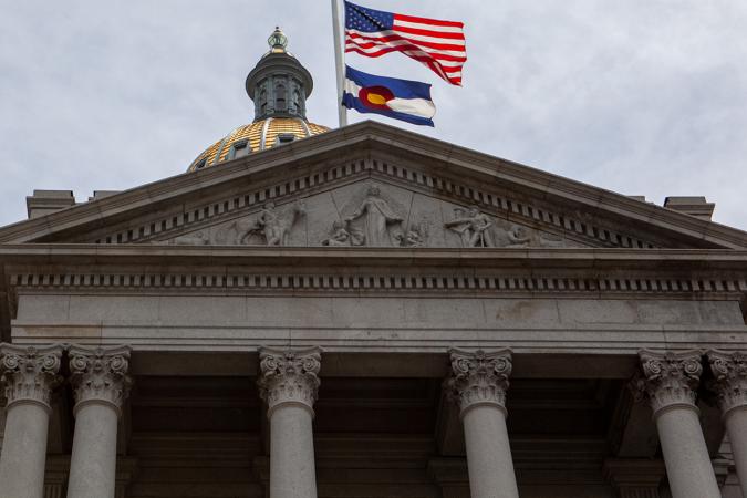Colorado State Capitol dome with U.S. and Colorado flags in the foreground