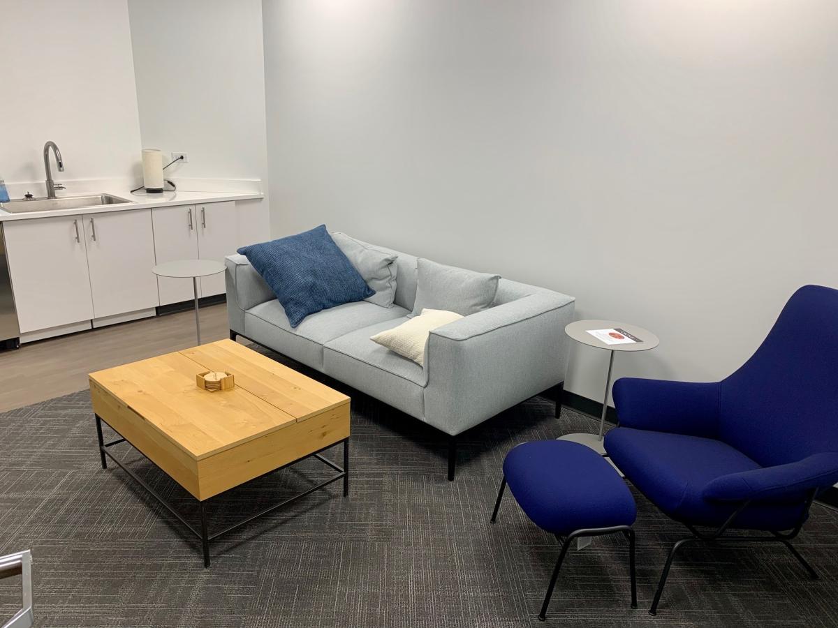 Lactation room with a couch, chair, low table and sink